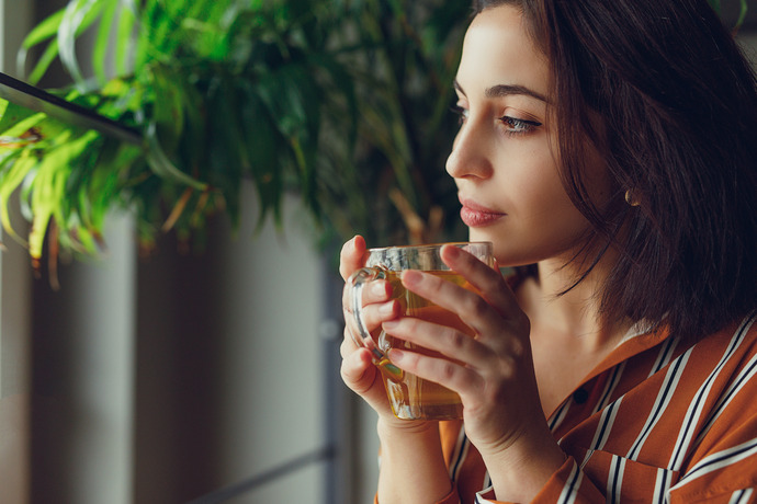 A person enjoying the benefits of green tea.